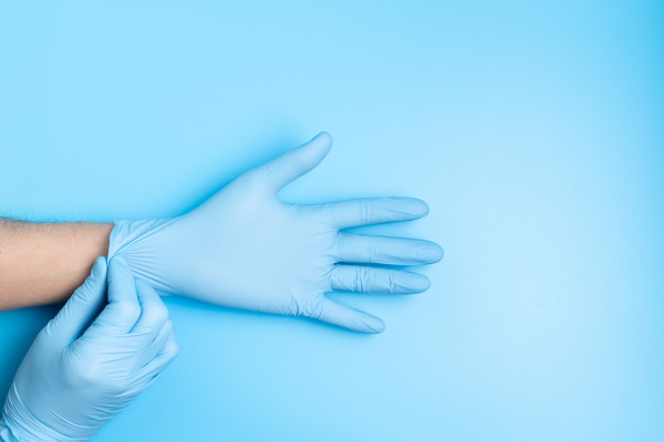 surgeon-putting-medical-gloves-on-28HKUJX